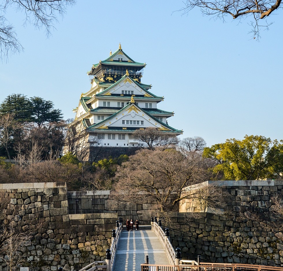 Far shot of Osaka Castle's main tower, showing entry from a bridge across the moat.