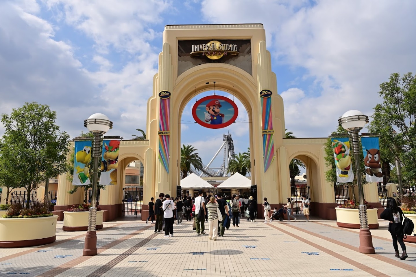 Front Entrance of Universal Studios Japan, with banners of various Super Mario Characters. Under the logo is a sign of Mario himself.